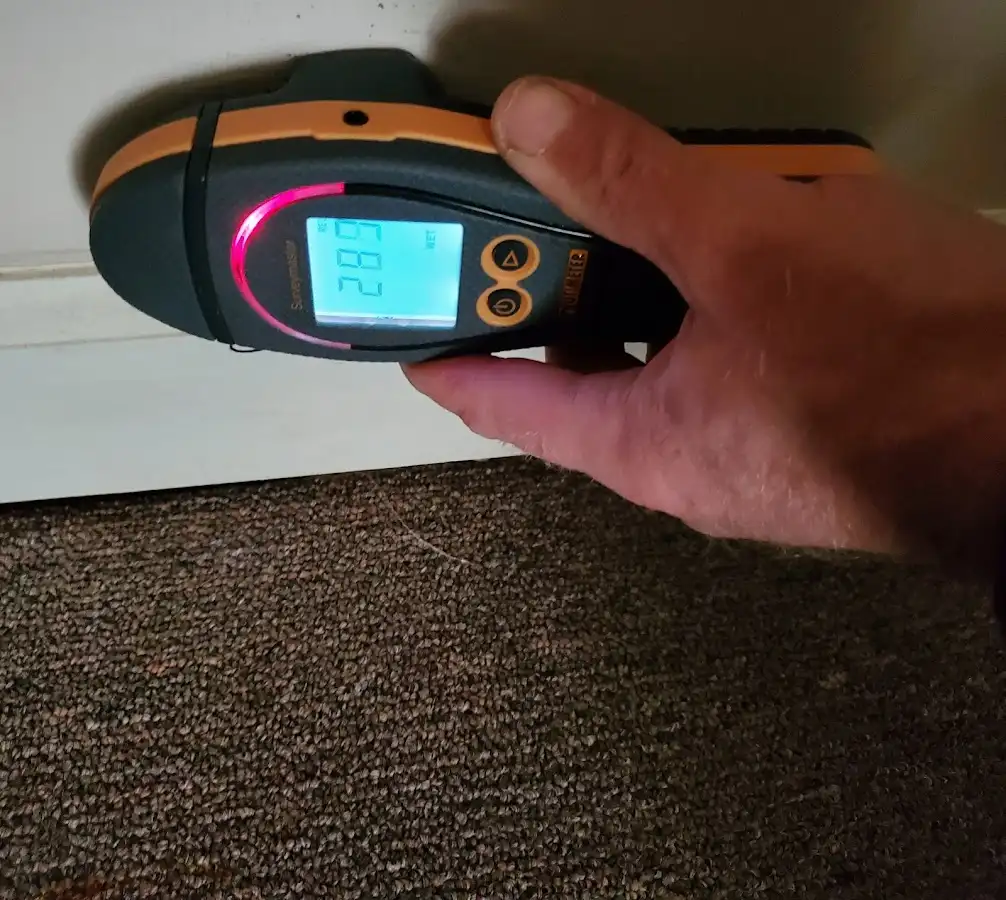 Moisture detection at baseboard during Storm Damage Restoration in Leisure City